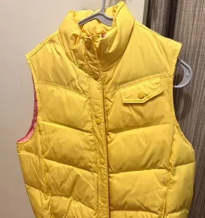 bright yellow Gap puffer vest with a contrasting pink lining and snap button closures thumbnail 1