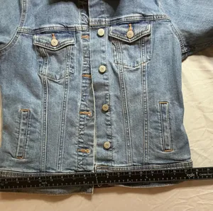The Old Navy Blue Denim Trucker Jacket is a classic button-up long sleeve jacket in a traditional trucker style. Made from denim, manufactured in Bangladesh.Pit to pit: 18 in. Length: 20 in. Pre-owned with no visible wear. Buttons are all intact and the jacket lays flat with no distortion thumbnail 7