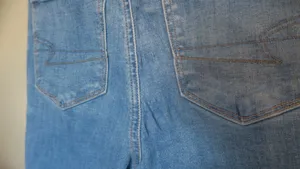 American Eagle Outfitters next level stretch super hi-rise flare jeans in medium wash blue size 4. thumbnail 13