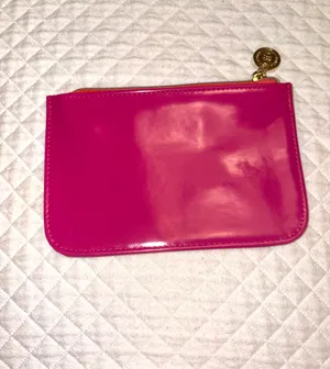 Small fuchsia pink patent leather makeup bag from Bath & Body Works with a gold metallic medallion pull. thumbnail 2