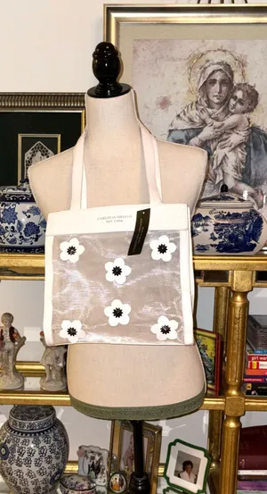 Christian Siriano's elegant translucent mesh tote bag stands out for its delicate black and white floral appliqués. thumbnail 1