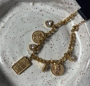 18k Gold multi charm bracelet with adjustable chain thumbnail 1