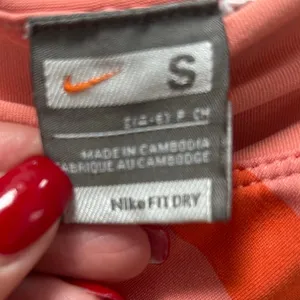 Nike Dri-FIT peach orange and pink diagonal-striped athletic skort size S thumbnail 4