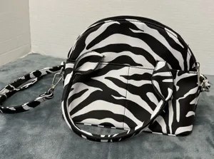 Olivia & Kate Zebra Striped Dumpling Bag thumbnail 1