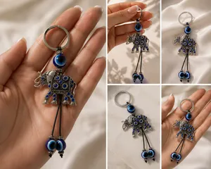 Cute elephant keychain with evil eye beads. It's made of metal with blue gem accents. Attaches to a standard key ring. thumbnail 5