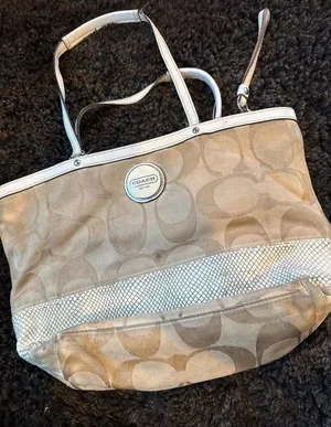 Signature coach bag with accent thumbnail 1