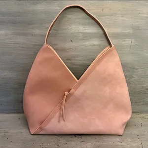 Hobo pink and tan shoulder bag with a unique asymmetrical design, featuring a side zipper closure thumbnail 1