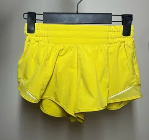 Lululemon yellow shorts with white reflective stripes #activewear #athletic thumbnail 1