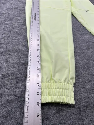 Nike Women's Sportswear Woven Pants in a bright neon green/yellow XS thumbnail 12