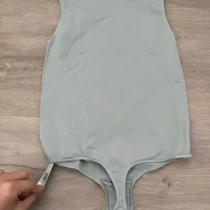 Skims Essential Bodysuit in Mineral Green thumbnail 8