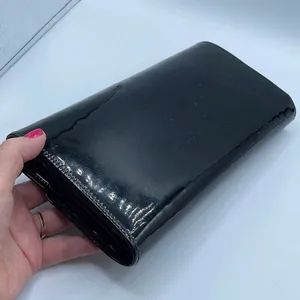 Black faux patent leather clutch with wave design on front. thumbnail 3