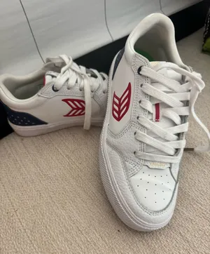 Patriotic Cariuma White Leather Sneakers with Red Logo and Navy Heel thumbnail 1