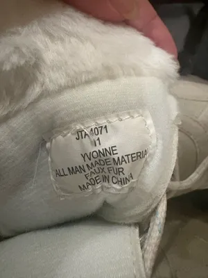 U.S. Polo Assn. Women's Yvonne Snow Boots in an "Oatmeal" or beige colorway. These mid-calf winter boots feature a duck-toe rubber shell base for slush protection, a quilted canvas shaft, traditional lace-up closure, and a plush faux-fur collar trim. A signature metallic logo plaque is attached to the side strap thumbnail 7