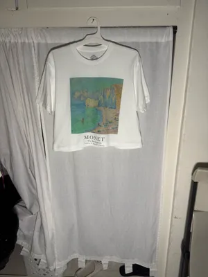 NWOT Monet Art Crop T Shirt White Graphic Tee The Beach Falaise d’Amont This NWOT Monet Art Crop T Shirt in white features a graphic design inspired by The Beach Falaise d’Amont 1889, making it a stylish and artistic addition to any woman's wardrobe. Made from 100% cotton, this regular fit tee has a crew neckline and a cropped style for a modern and trendy look. Perfect for art enthusiasts or those looking to add a unique touch to their outfit, this T-shirt is comfortable and versatile, ideal for everyday wear. thumbnail 9