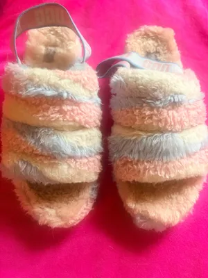 The UGG Women's Fluff Yeah Slide Cali Collage in the "Cotton Candy" color-way features a pastel striped blend of pink, blue, and white/cream. This highly popular, statement-making slipper combines the breathability of a slide sandal with the premium warmth of traditional house shoes Preloved Machine washed on delicate & sun/air-dried & ready for their mew home Note: these are preloved and worn still in perfect shape structurally- but no longer look new - even though they are washed - they don’t look like new thumbnail 3