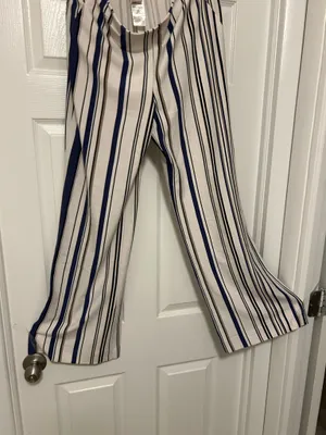 CHICO’S Stylish wide-leg pants in a navy and white striped pattern. Lightweight, flowy fabric for all-day comfort. Versatile design that dresses up or down. Easy to pair with tops and sandals. thumbnail 6