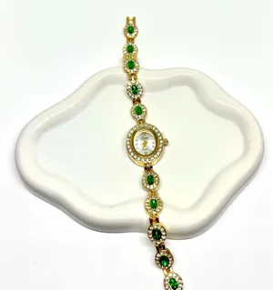 Luxury women’s watch sparkly emerald green stone thumbnail 1