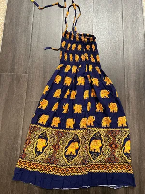 Flowy halter maxi dress with a smocked bodice. Navy base with repeating golden elephant motif. Decorative border print at hem. Lightweight and breezy. Adjustable tie straps. thumbnail 4