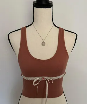 terracotta rust tank with white lace, three mauve pink rosebuds, & a white ribbon bow 🌷🤍✨ thumbnail 1