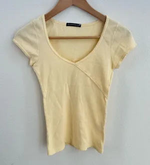 yellow Brandy Melville tee with a cute criss-cross detail thumbnail 1