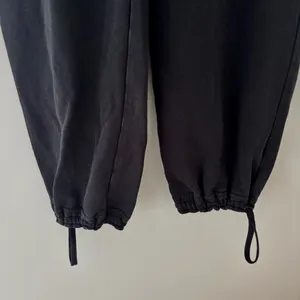 Black Nike sweatpants with drawstring waist and adjustable cuffs thumbnail 2