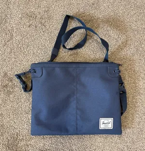 Herschel navy blue crossbody bag with red/white striped lining thumbnail 1
