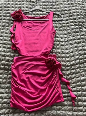 Amazon Stand out in this bright pink one-shoulder dress. Features ruched skirt detailing and floral accents for a feminine touch. Comfortable stretch fabric with an asymmetrical silhouette. Perfect for parties and evening occasions. thumbnail 1