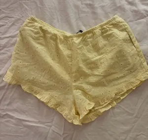 Grey Bandit NWT Eyelet Ruffle Hem Athletic Shorts in Pale Yellow thumbnail 1