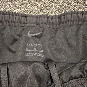 Nike Women's Athletic Shorts in Black and Red thumbnail 4