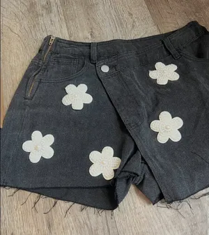 POL black denim skort features distinctive pearl-embellished flower details thumbnail 1