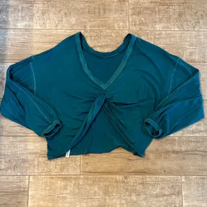 Teal long-sleeve crop top with a front twist detail. thumbnail 2