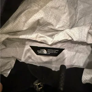 Black north face rain jacket thumbnail 2