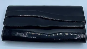 Black faux patent leather clutch with wave design on front. thumbnail 1