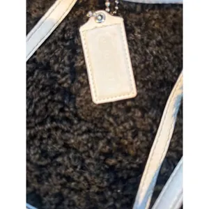 Signature coach bag with accent thumbnail 16