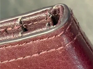 Fossil pebbled leather tab clutch wallet in a deep burgundy or berry color thumbnail 4