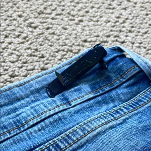 Denizen from Levi's Distressed Blue Low Rise Jeans thumbnail 9