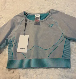 Gymshark Women's Teal and Gray Long Sleeve Crop Top Size Small . Stylish long sleeve crop top by Gymshark. Features a sleek teal and gray design. Perfect for workouts.. NWT thumbnail 5