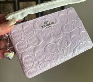 Authentic COACH patent signature leather zip top wristlet with a heart charm thumbnail 1
