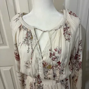 The American Rag Long Sleeve Lace Up Bodice Floral Dress in Cream is a stylish and versatile option for women. This fit & flare dress features a floral pattern in cream, pink, and white, making it perfect for various occasions such as travel, weddings, parties, or casual outings. The long sleeves and lace-up bodice add a touch of elegance, while the short dress length adds a trendy flair. Made from a blend of rayon, cotton, polyester, and linen, this dress offers both comfort and style for women in size M. thumbnail 2