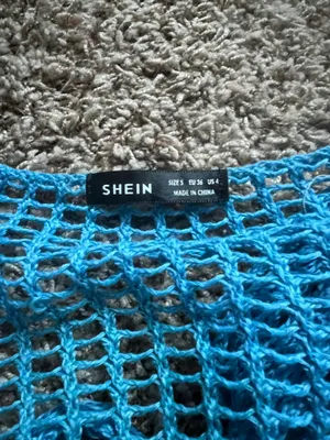 SheIn Lightweight open-knit crop top with tie-front detail. Matching crochet mini skirt with scalloped hem. Vibrant turquoise color perfect for layering or beachwear. thumbnail 3