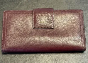 Fossil pebbled leather tab clutch wallet in a deep burgundy or berry color thumbnail 1
