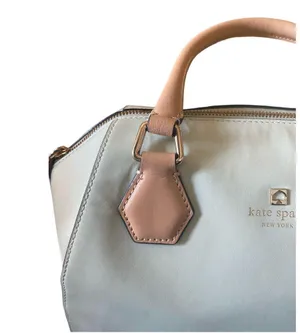 Kate Spade NEW YORK-MINT MOJITO PIPPA PARNELL STREET LEATHER SATCHEL Perfect spring bag, mint green white tan handle and crossbody strap, top zip closure, stripe print interior, inside zip pocket, inside two open pockets, amazing condition, there are two call outs, a small smudge on the bottom of the bag and a small smudge on one corner, please see the last two pictures **This bag is preowned and is being sold as is** thumbnail 7