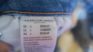 American Eagle Outfitters next level stretch super hi-rise flare jeans in medium wash blue size 4. thumbnail 15