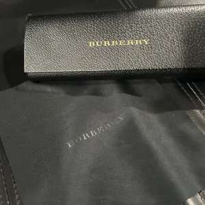 Burberry Black Case with Gold Logo includes Burberry cleaning cloth. thumbnail 1