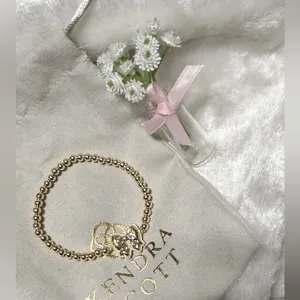 Kendra Scott Haley Bow Gold Stretch Bracelet featuring a custom-carved pink bow thumbnail 4