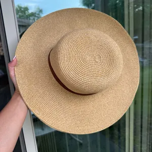 Something special wide brimmed straw hat with brown ribbon hand thumbnail 2