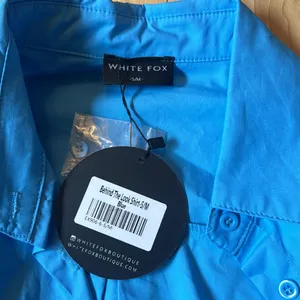 White fox behind the look shirt thumbnail 3