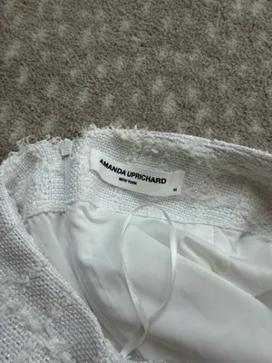 Chic white mini skirt with textured horizontal detailing. Slim, flattering silhouette. Easy to pair with tops or jackets for polished looks. thumbnail 3