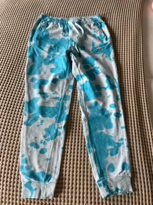 Comfortable aqua and white tie-dye joggers. Elastic waistband with drawstring for a secure fit. Side pockets and ribbed cuffs for everyday wear. Soft fabric keeps relaxed and stylish in aqua pattern. thumbnail 3