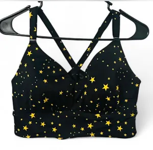 Torrid Black and yellow star print bikini top with adjustable straps and removable padding. Straps can be removed if you prefer to not have a racer back. Size 12 D/DD. Excellent condition. All offers accepted. Shipping next day. thumbnail 1